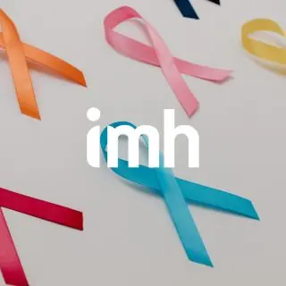 Colourful awareness ribbons (orange, pink, yellow, red, and blue) are arranged on a white background. The lowercase letters imh appear in bold white text over the centre of the image.